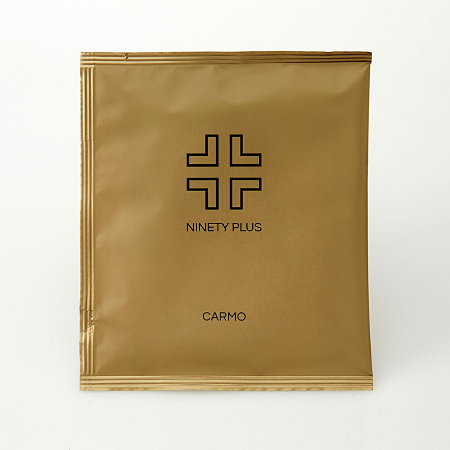 Gold package with 'Ninety Plus' and 'Carmo' branding on a white background