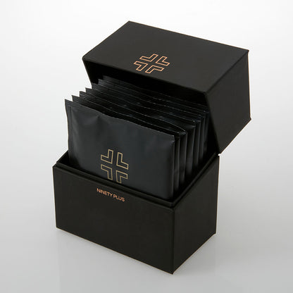 Black packaging box with multiple black packets inside, featuring a logo and brand name.