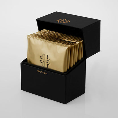 Black box with gold packets inside on a white background