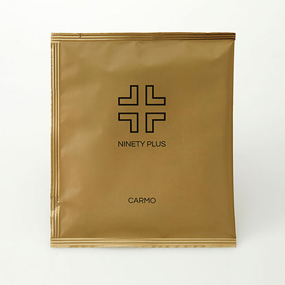 Gold package with 'Ninety Plus' and 'Carmo' branding on a white background