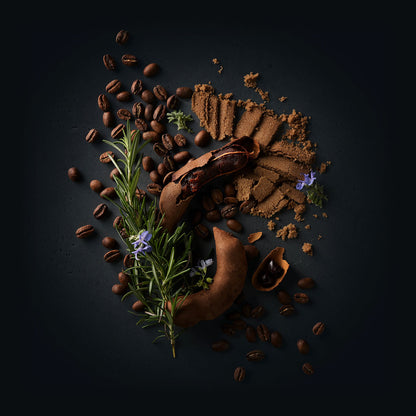 Sillvia Coffee by Ninety Plus Coffee.  A spread of roasted coffee beans with food items that represent that flavor notes of brown sugar, tamarind, and rosemary. 